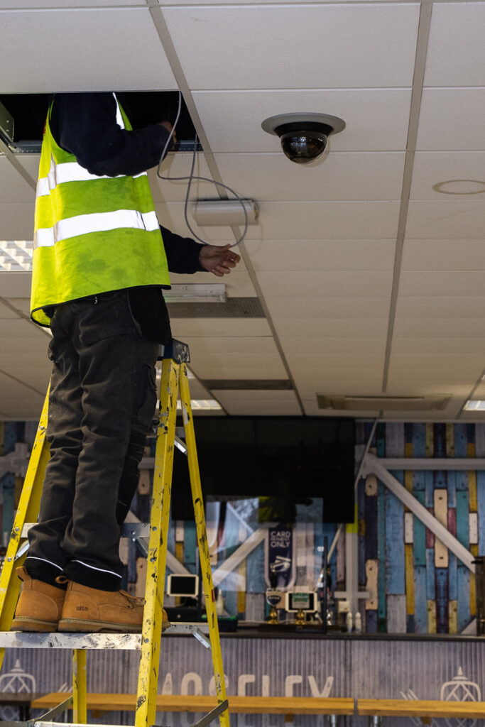 Engineer installing internal CCTV camera